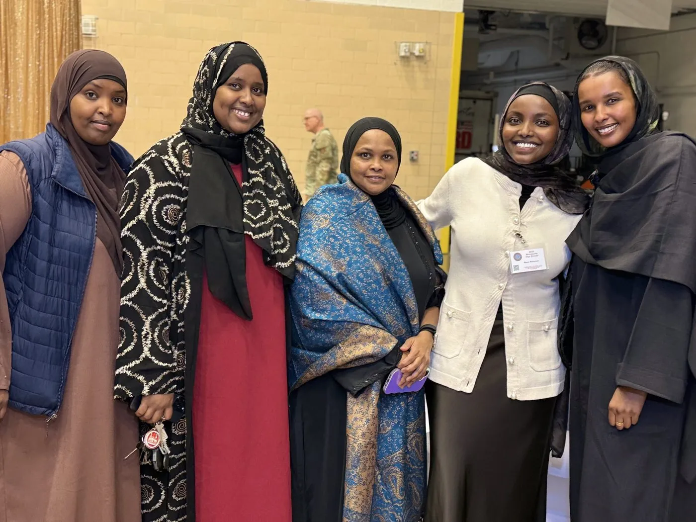Five women from the Maangaar Voices community stand together at an event.