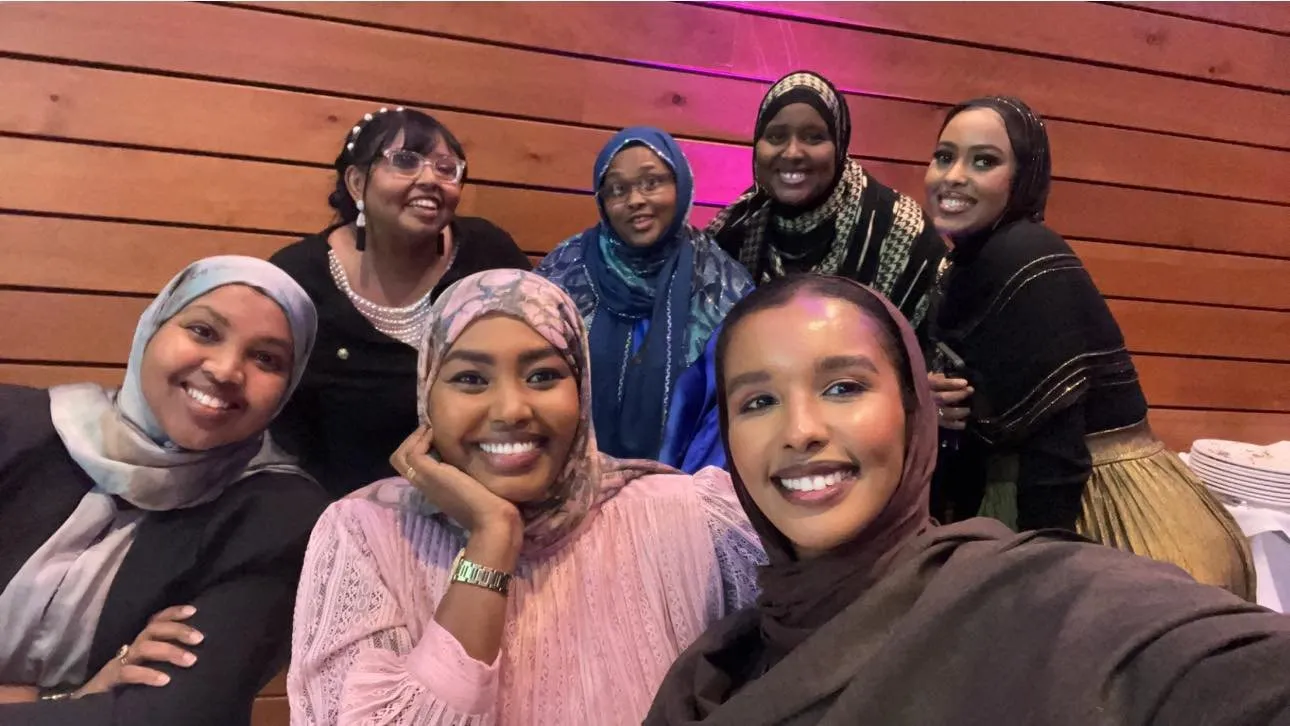 A group of women from the Maangaar Voices community take a smiling selfie together.