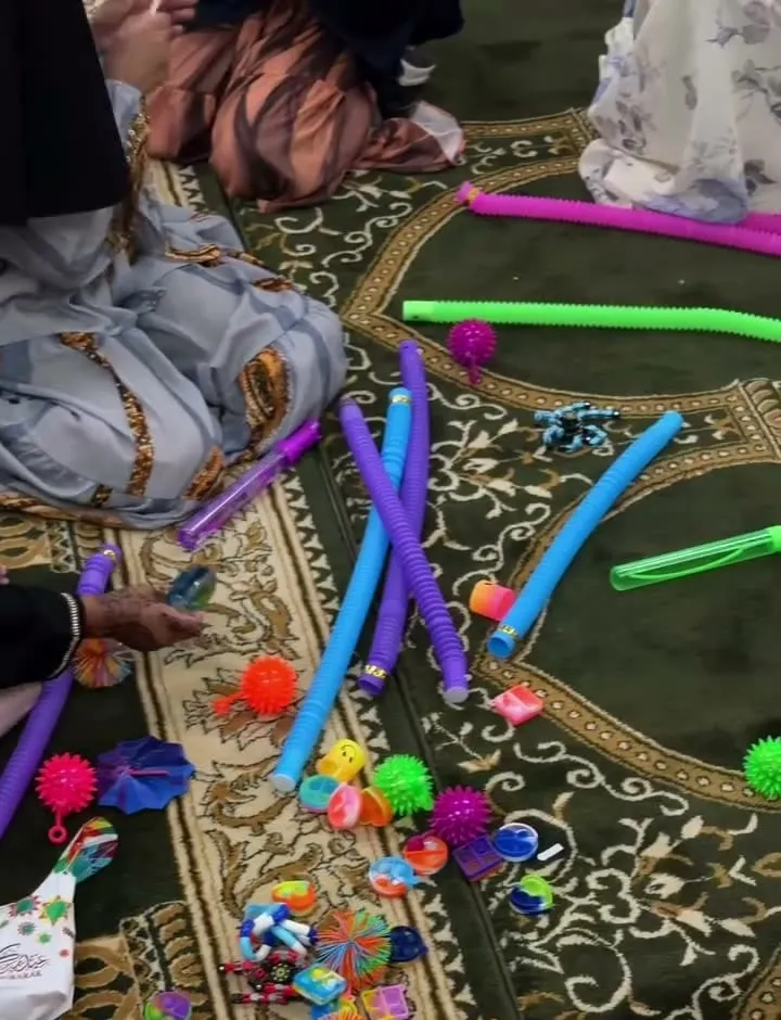 Pool noodles, fidget toys and sensory balls spread across the prayer carpet.
